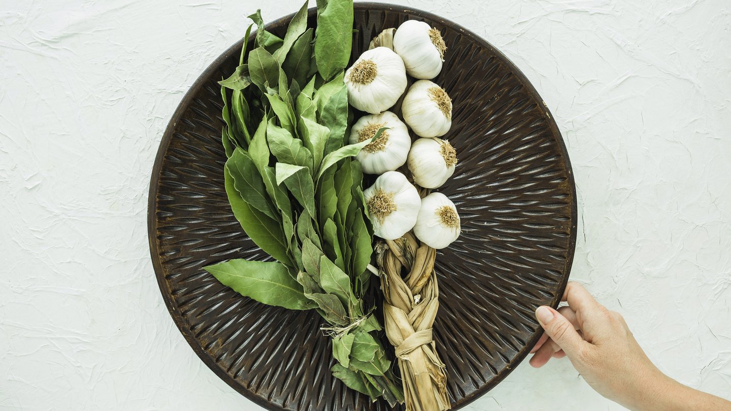 Preparing a balanced everyday meal with vegetables, greens, fish, and eggs in a home kitchen